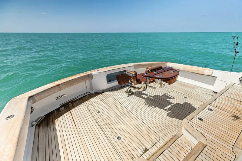 Big Game Yacht Photos Pics 2006 Hatteras 68 Convertible yacht deck with fishing chair, overlooking calm ocean waters.