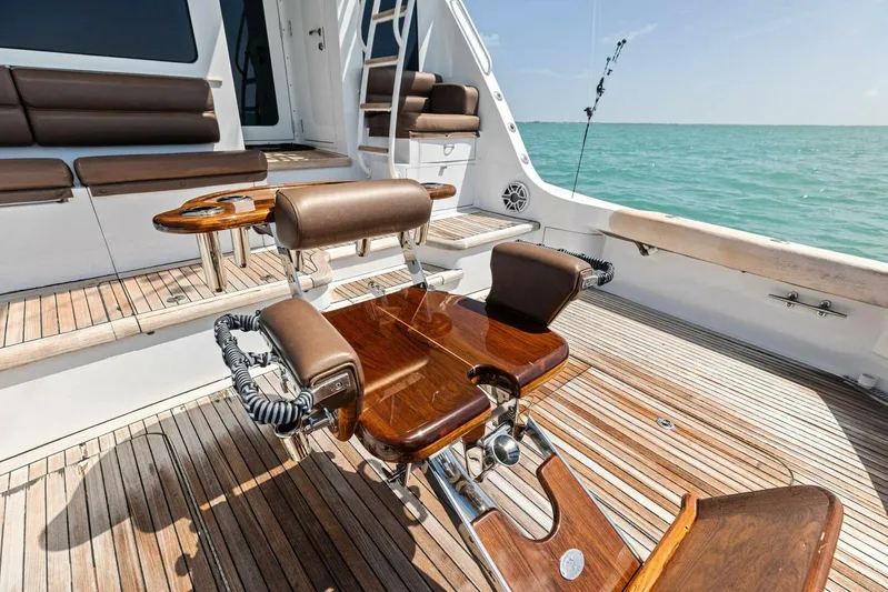 Big Game Yacht Photos Pics Luxury deck of 2006 Hatteras 68 Convertible yacht with wooden seating and ocean view.