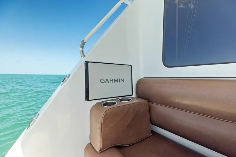 Big Game Yacht Photos Pics 2006 Hatteras 68 Convertible boat interior with Garmin panel and brown seating.