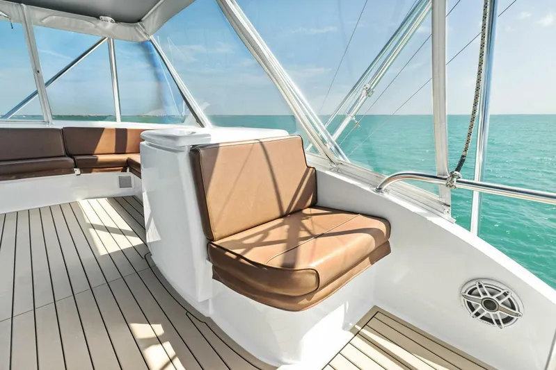 Big Game Yacht Photos Pics Luxurious seating on 2006 Hatteras 68 Convertible yacht, overlooking serene ocean waters.