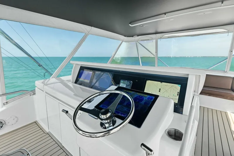 Big Game Yacht Photos Pics Helm of 2006 Hatteras 68 Convertible yacht with navigation screens and ocean view.
