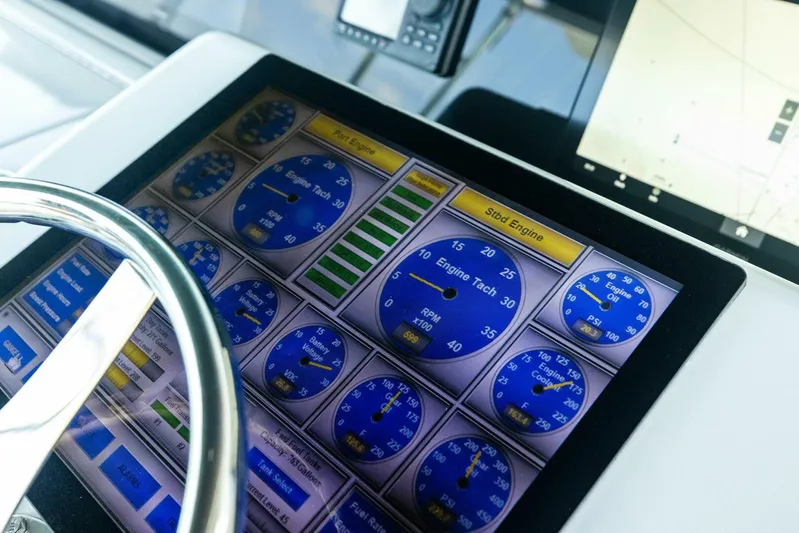 Big Game Yacht Photos Pics Control panel of a 2006 Hatteras 68 Convertible yacht, displaying engine gauges.