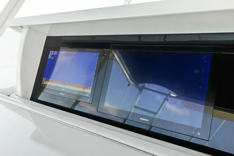 Big Game Yacht Photos Pics Garmin navigation screens on 2006 Hatteras 68 Convertible yacht dashboard.