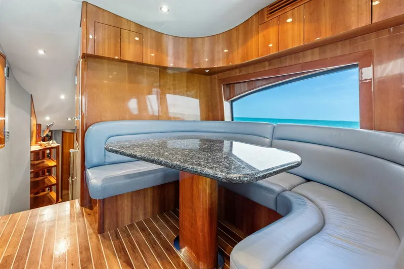 Big Game Yacht Photos Pics Luxurious interior of 2006 Hatteras 68 Convertible yacht with elegant wood and leather seating.