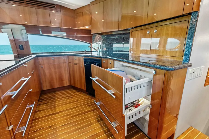 Big Game Yacht Photos Pics Luxurious kitchen interior of 2006 Hatteras 68 Convertible yacht with ocean view.