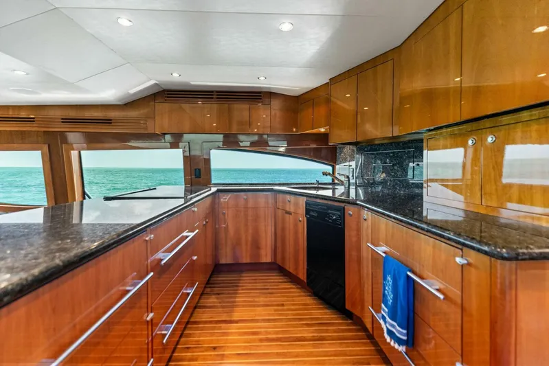 Big Game Yacht Photos Pics Luxurious kitchen interior of 2006 Hatteras 68 Convertible yacht with ocean view.