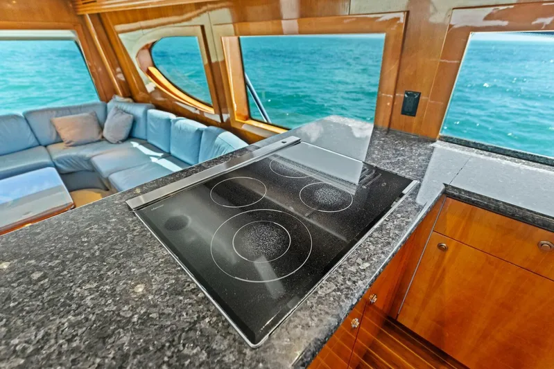 Big Game Yacht Photos Pics Luxurious 2006 Hatteras 68 Convertible yacht interior with modern kitchen and ocean view.