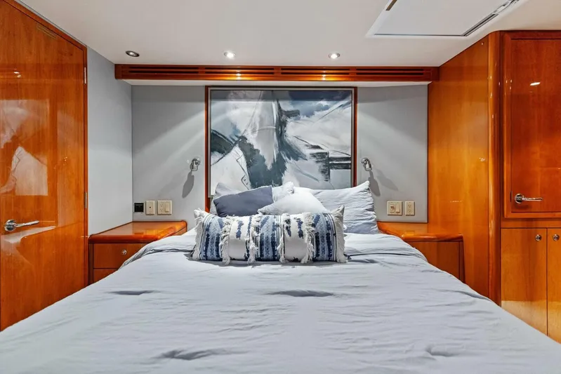 Big Game Yacht Photos Pics Luxurious bedroom interior of 2006 Hatteras 68 Convertible yacht with modern decor.