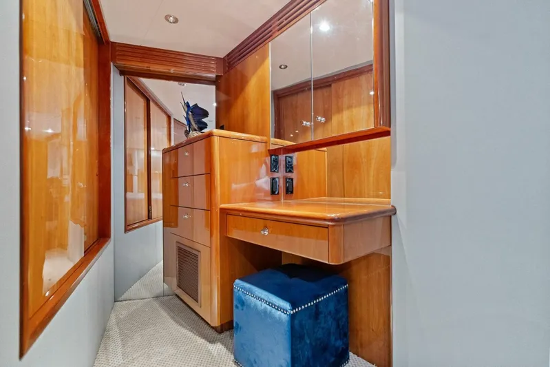 Big Game Yacht Photos Pics Luxurious wooden vanity area inside 2006 Hatteras 68 Convertible yacht with blue stool.