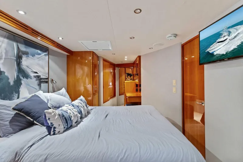 Big Game Yacht Photos Pics Luxurious bedroom interior of 2006 Hatteras 68 Convertible yacht with modern decor and cozy bedding.