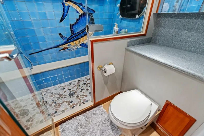 Big Game Yacht Photos Pics Bathroom in 2006 Hatteras 68 Convertible yacht with marlin tile design and pebble shower floor.