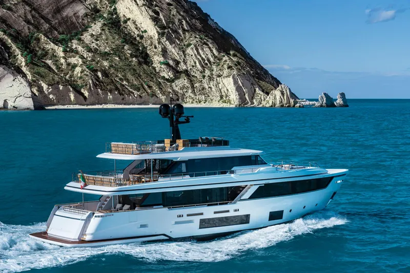  Yacht Photos Pics Luxury yacht Custom Line Navetta 30, 2023, cruising near rocky coastline.