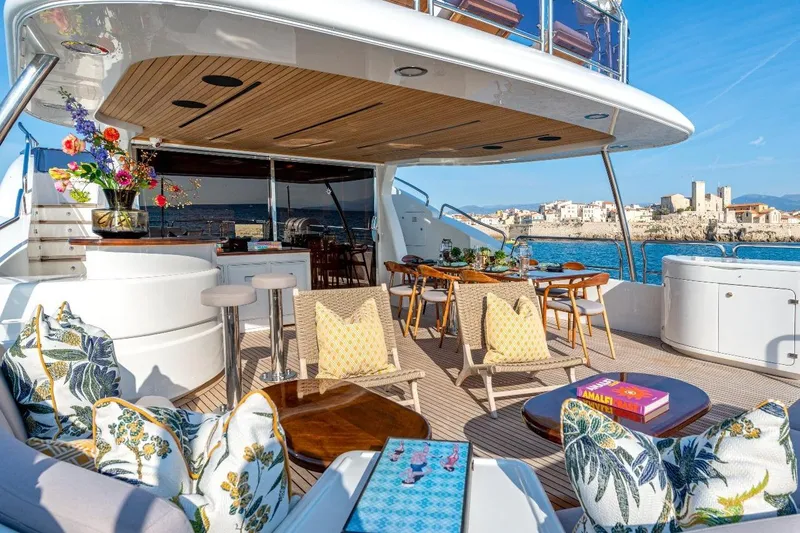 New Star Yacht Photos Pics Luxurious Benetti Tradition 100 yacht deck with elegant seating, dining area, and ocean view.