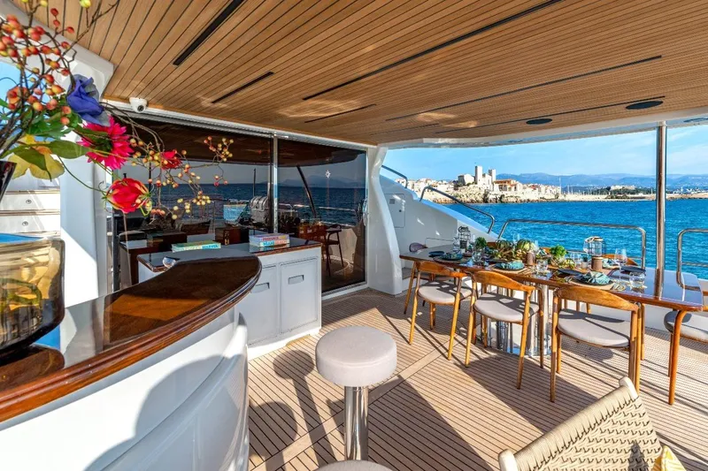 New Star Yacht Photos Pics Luxurious Benetti Tradition 100 yacht deck with elegant dining setup, ocean view, and floral decor.