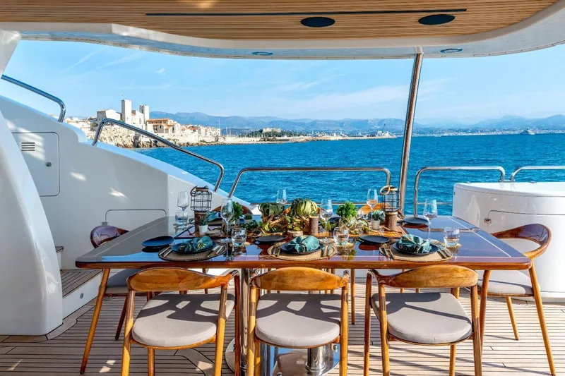 New Star Yacht Photos Pics Luxurious dining setup on 2002 Benetti Tradition 100 yacht with ocean view.