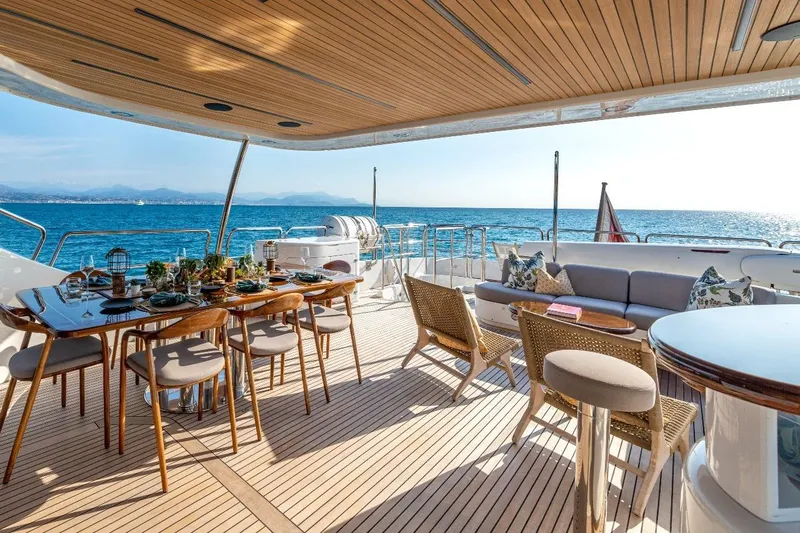 New Star Yacht Photos Pics Luxurious Benetti Tradition 100 yacht deck with elegant dining setup, ocean view, 2002 model.