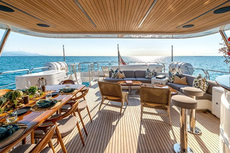 New Star Yacht Photos Pics Luxurious 2002 Benetti Tradition 100 yacht deck with elegant dining and seating area.