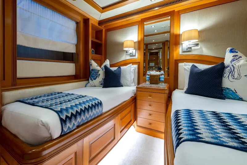 New Star Yacht Photos Pics Luxurious twin cabin interior on 2002 Benetti Tradition 100 yacht, featuring elegant wood finishes.