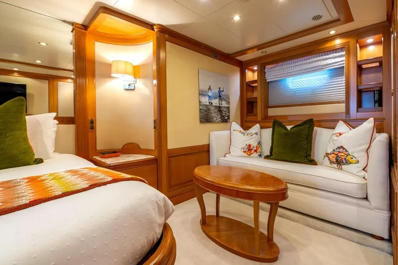 New Star Yacht Photos Pics Luxurious interior of 2002 Benetti Tradition 100 yacht with elegant wood finishes and cozy seating.