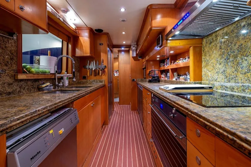 New Star Yacht Photos Pics Luxurious kitchen interior on a 2002 Benetti Tradition 100 yacht, featuring granite countertops.