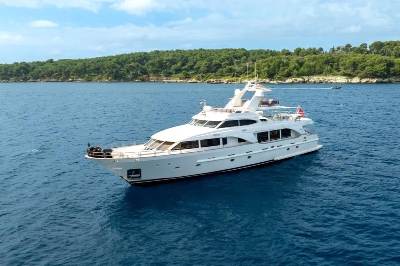 New Star Yacht Photos Pics Luxurious 2002 Benetti Tradition 100 yacht cruising on serene blue waters.