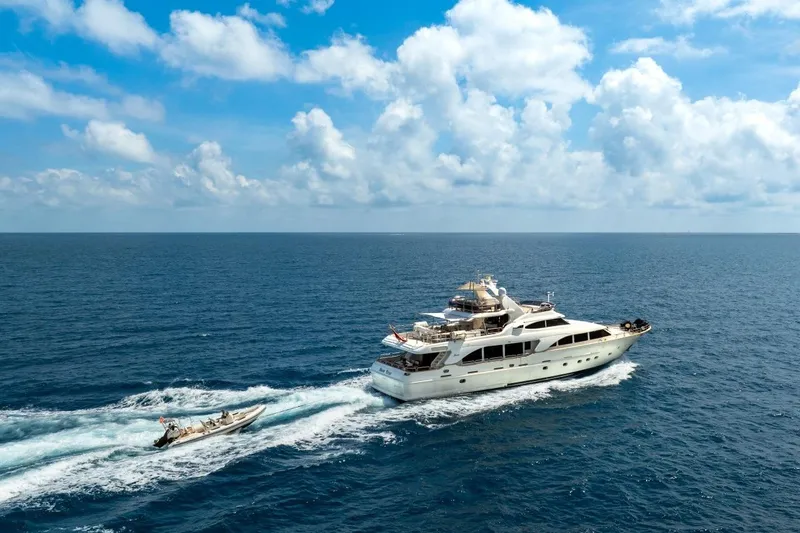 New Star Yacht Photos Pics Benetti Tradition 100 yacht cruising on open sea under a bright blue sky.