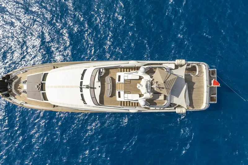 New Star Yacht Photos Pics Aerial view of 2002 Benetti Tradition 100 yacht on blue ocean water.
