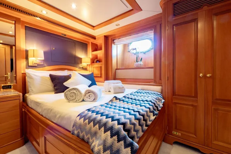 New Star Yacht Photos Pics Luxurious cabin interior of 2002 Benetti Tradition 100 yacht with elegant wood finishes.