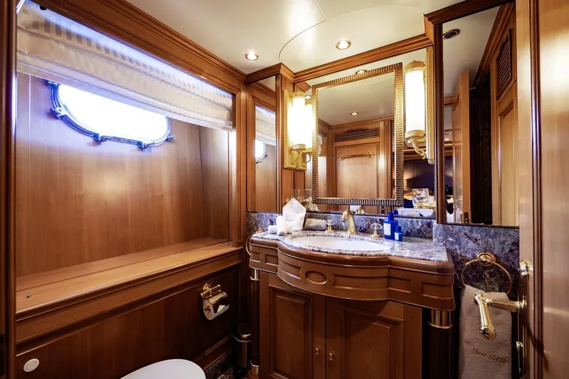 New Star Yacht Photos Pics Luxurious bathroom in 2002 Benetti Tradition 100 yacht, featuring elegant wood and marble finishes.