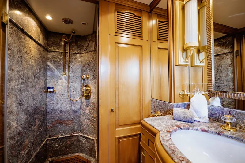New Star Yacht Photos Pics Luxurious bathroom on 2002 Benetti Tradition 100 yacht with marble and wood finishes.