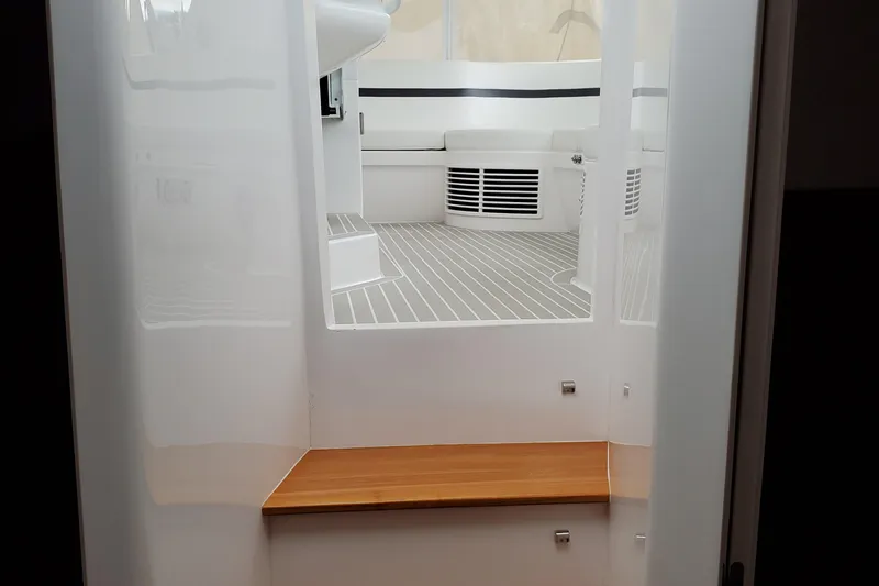 Her Salt Bouys Yacht Photos Pics 2019 Intrepid 475 Sport Yacht interior with sleek white design and wooden accents.