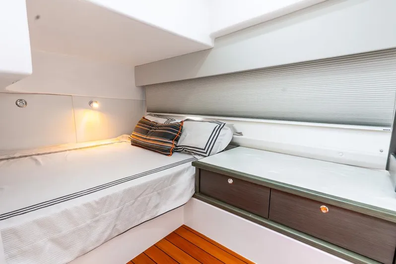 Her Salt Bouys Yacht Photos Pics 2019 Intrepid 475 Sport Yacht cabin with bed, wooden flooring, and modern design.