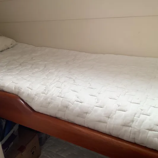 Lauralea Yacht Photos Pics 2006 Cabo 35 Flybridge Sportfisher cabin with a neatly made bed and wooden frame.