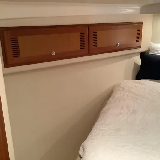 Lauralea Yacht Photos Pics Interior cabin of 2006 Cabo 35 Flybridge Sportfisher with wooden storage and bedding.