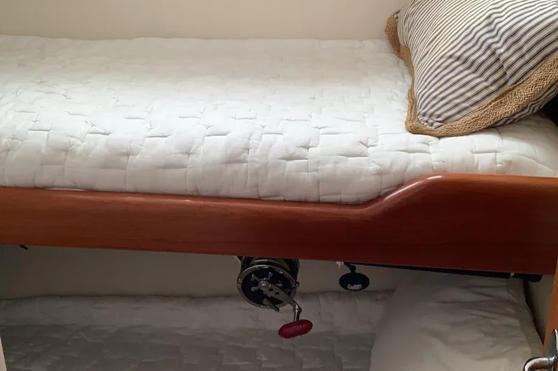 Lauralea Yacht Photos Pics Interior of 2006 Cabo 35 Flybridge Sportfisher with cozy bedding and striped pillow.