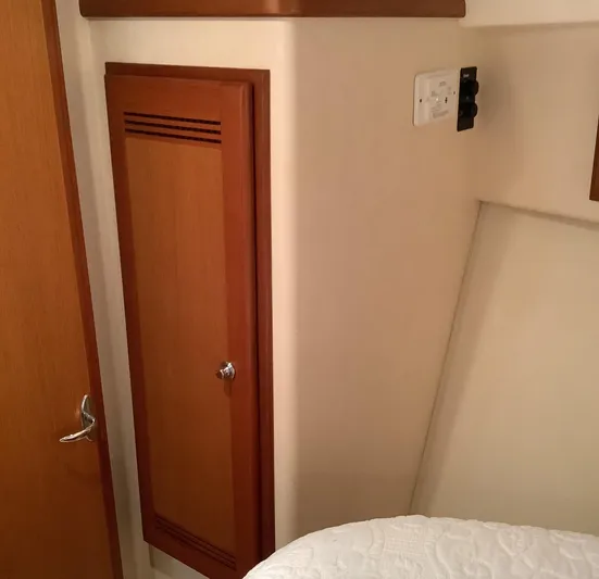 Lauralea Yacht Photos Pics Interior of 2006 Cabo 35 Flybridge Sportfisher, featuring wooden cabinet and control panel.