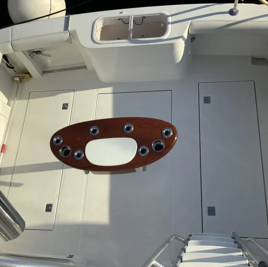 Lauralea Yacht Photos Pics 2006 Cabo 35 Flybridge Sportfisher deck with fishing rod holders and storage compartments.