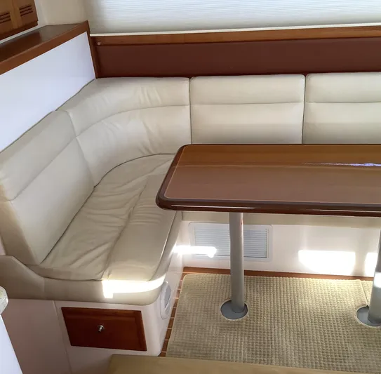 Lauralea Yacht Photos Pics 2006 Cabo 35 Flybridge Sportfisher interior with beige seating and wooden table.
