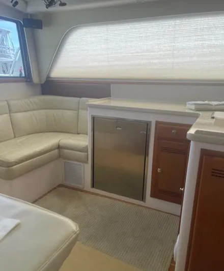 Lauralea Yacht Photos Pics 2006 Cabo 35 Flybridge Sportfisher interior with beige seating and compact kitchenette.