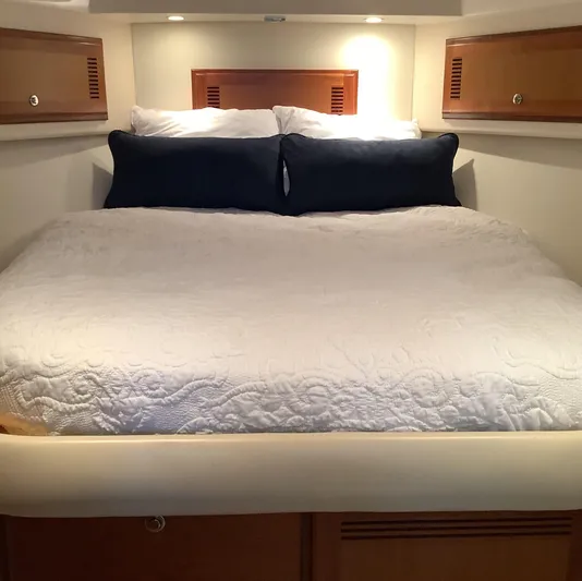 Lauralea Yacht Photos Pics Luxurious cabin interior of 2006 Cabo 35 Flybridge Sportfisher with cozy bedding.