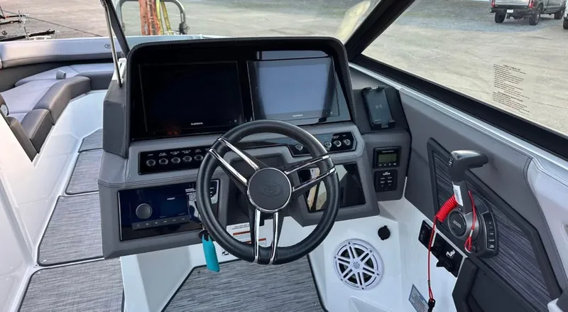  Yacht Photos Pics 2022 Cobalt R8 boat dashboard with steering wheel, dual screens, and control panel.