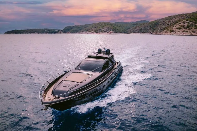  Yacht Photos Pics Luxury 2006 Riva 68 Ego yacht cruising on serene waters at sunset.