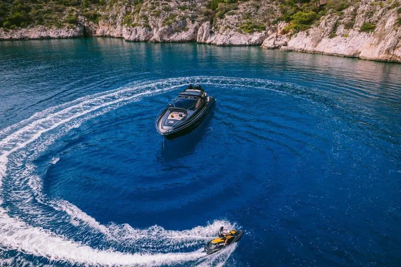  Yacht Photos Pics Riva 68 Ego yacht and jet ski in scenic blue waters, 2006 model.