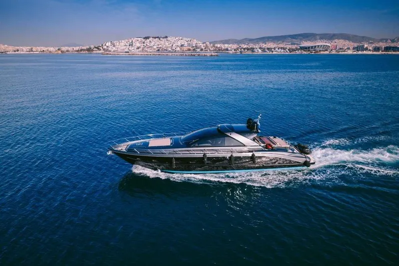  Yacht Photos Pics 2006 Riva 68 Ego yacht cruising on blue ocean near coastal cityscape.