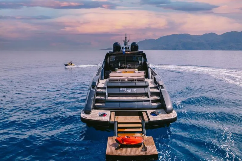  Yacht Photos Pics Luxury 2006 Riva 68 Ego yacht on serene ocean with scenic sunset backdrop.