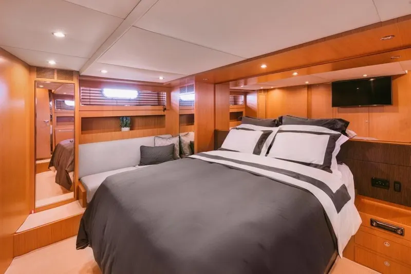  Yacht Photos Pics Luxurious 2006 Riva 68 Ego yacht bedroom with elegant wood finish and modern amenities.