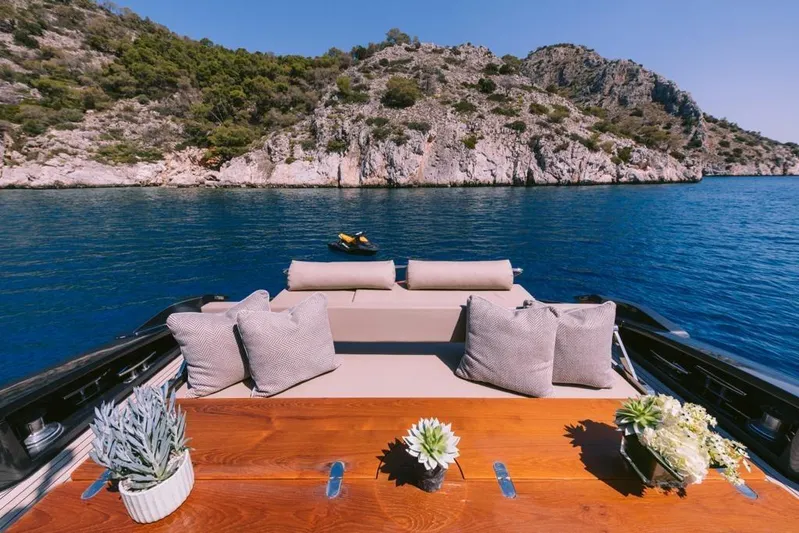  Yacht Photos Pics Luxurious 2006 Riva 68 Ego yacht with elegant deck, cushions, and scenic coastal view.