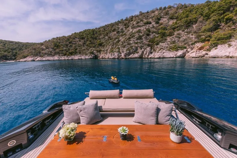  Yacht Photos Pics Luxurious 2006 Riva 68 Ego yacht with scenic coastal view and elegant deck seating.