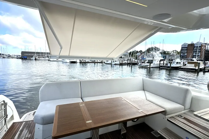 Lady Jane III Yacht Photos Pics 2023 Prestige 520 yacht with shaded seating area overlooking marina.