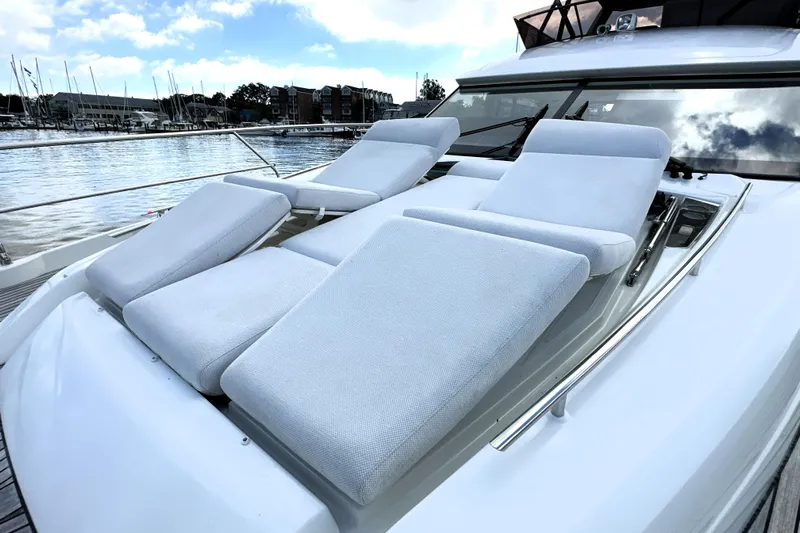 Lady Jane III Yacht Photos Pics 2023 Prestige 520 yacht with luxurious sun loungers on deck, docked at marina.